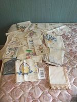 Assorted embroidered linens spread on bed