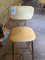 Front view of chair showing overall design and vinyl upholstery