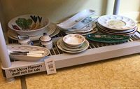 All items on shelf including serving bowl, egg tray, platters, dishes, creamer, sugar bowl, knives