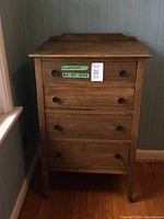 full front view of the dresser with four drawers and knobs
