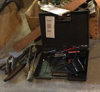 Closed view of case with soldering gun and accessories visible