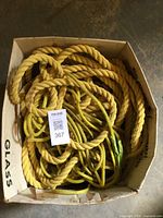 Box containing mixed coils of yellow rope