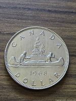 Full reverse view showing canoe design, date, CANADA DOLLAR legend
