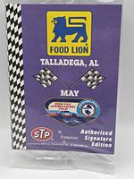Front of sealed pack showing Food Lion logo, Richard Petty emblem, STP logo, Talladega AL May text