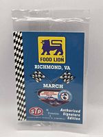 Front of sealed blue promotional card pack showing Food Lion logo, Richmond VA March, checkered border