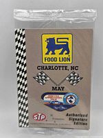 Front of sealed promotional card showing Food Lion logo, racing flags, STP logo