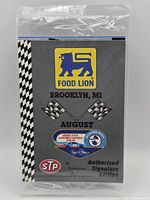 Front of sealed trading card pack showing Food Lion logo, event details, logos