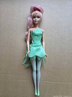 Full-length view of the Barbie doll showing outfit, hair, and overall condition