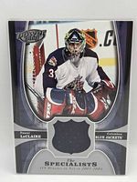 Front of card showing player image, shield window with jersey swatch and set branding