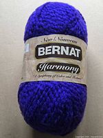 Front label showing Bernat Harmony branding on purple yarn skein