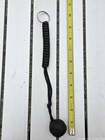 Full view of keychain next to ruler showing overall length and components