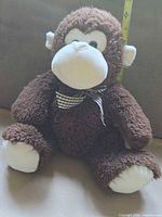 Front view seated plush monkey showing colors, bow, eyes