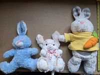 Three plush rabbits side by side