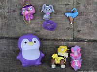 Overhead view of all seven toys on wooden surface