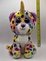 Front view of plush with ruler for scale