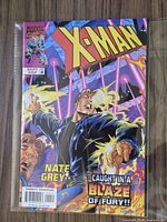 Front cover of X-Man #42 comic bagged and boarded