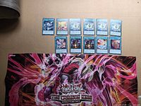 All cards laid out in two rows above folded Crimson King playmat