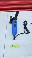 Full view of angle grinder with cord, handle and guard