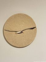 Front view of round sand-textured plaque with seagull design