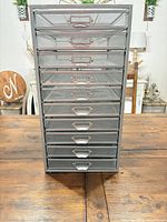 Front view showing ten drawers and copper-tone handles