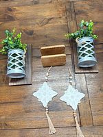 overview of both wall sconces, wooden stand, two macramé ornaments