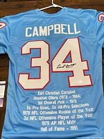 Full back view of signed Earl Campbell jersey showing name, number, signature, printed career stats