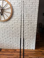 Full length view of both Penn Squall rods leaning against wall