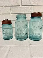 Three aqua blue Ball Perfect Mason jars with lids