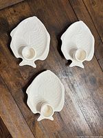 Three ceramic fish platters with dip cups on wooden table