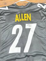 Full rear view showing name, number, autograph, COA sticker