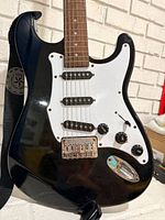Full front view of guitar showing body, neck, strap
