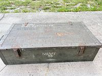 Top view of wooden military crate showing hinges and overall wear.