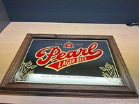 Full view of framed Pearl Lager Beer mirror on tabletop