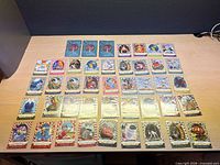 All 40 cards laid out in rows with three guide booklets placed above