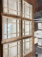 All six square wood-framed mirrors laid out together