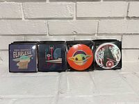 Four boxed coaster designs side by side