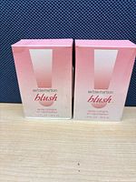 Front view of two sealed Exclamation Blush perfume boxes