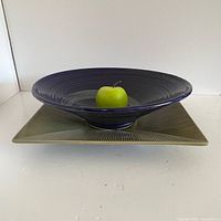 Both ceramic pieces together for size and style reference, apple for scale