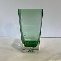 Full front view of square green cased glass vase