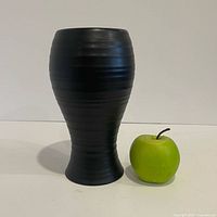 Front view showing full vase beside apple for scale