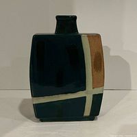 Front view of dark green rectangular ceramic vase with cream and brown geometric banding