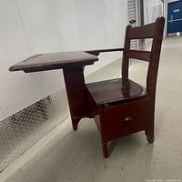 full view of desk-chair showing writing surface, seat, drawer front, burgundy finish