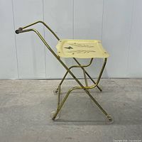Side view of folded-out cart showing frame, tray, handle, wheels