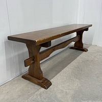 Front angled view of full bench showing trestle legs and stretcher