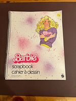 Front cover showing Barbie illustration, title, and spiral binding