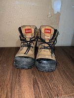 Front view of both boots showing uppers, laces, toe guards, brand patches