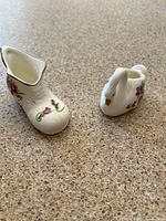 Swan and shoe miniature creamers side by side