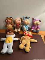 Six Cabbage Patch Cuties dolls displayed together