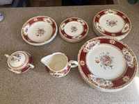 Full set laid out showing plates, bowls, creamer and sugar bowl