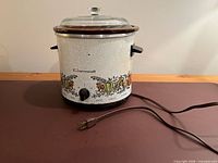 Slow cooker assembled with lid and cord visible